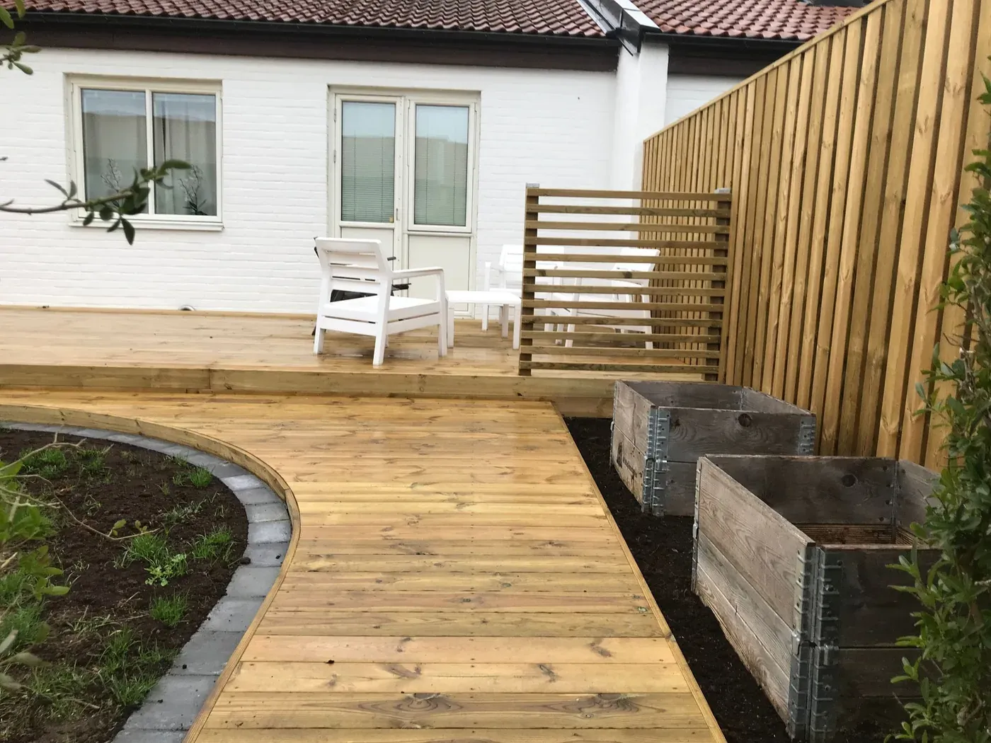 Terrass med gång i trä. Utfört av Wood & Stone.