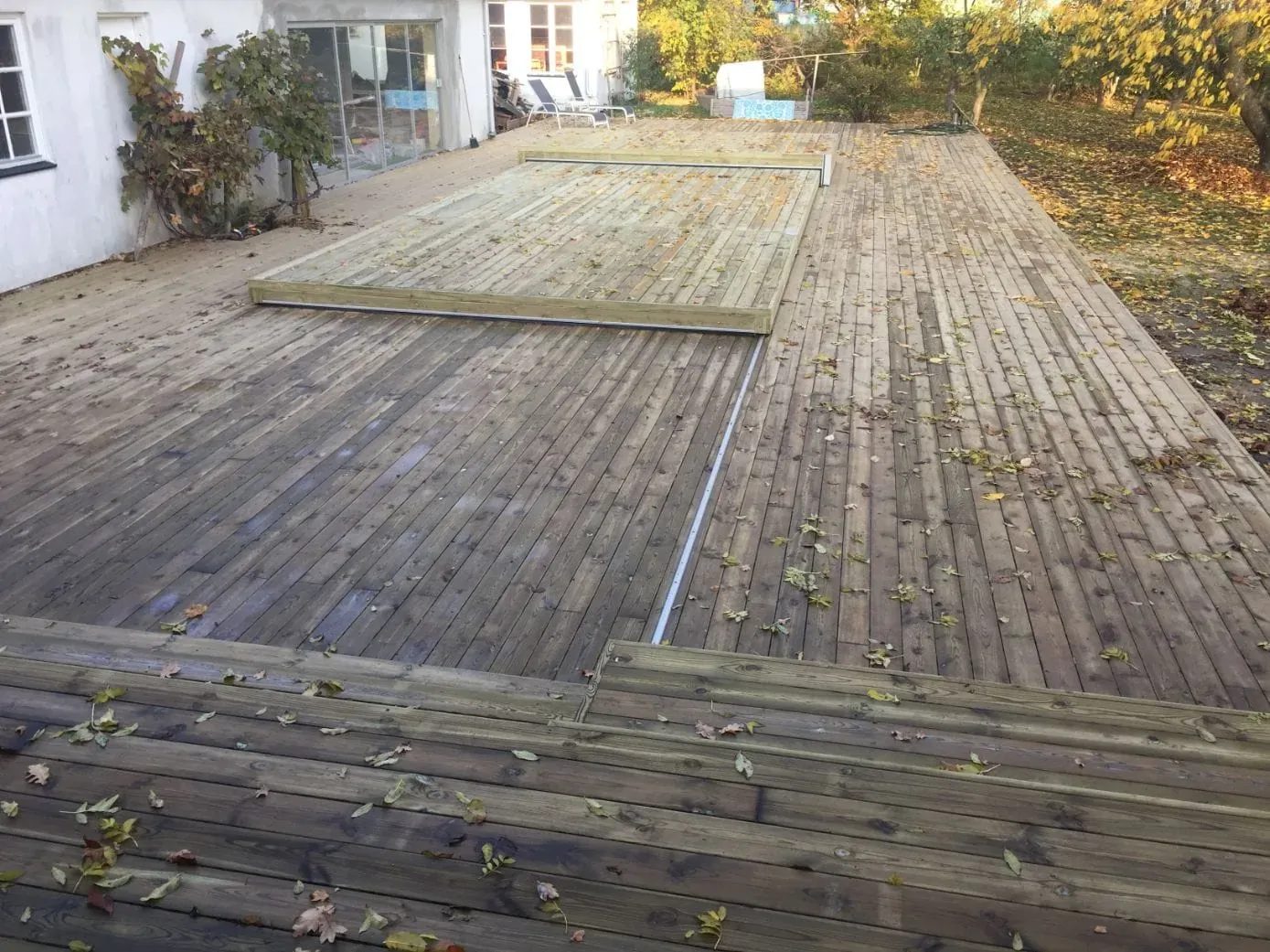 Stort trädäck med dolda skruvar runt en pool